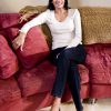 Portrait of mid-adult woman of Indian ethnicity relaxing at home in living room  on sofa